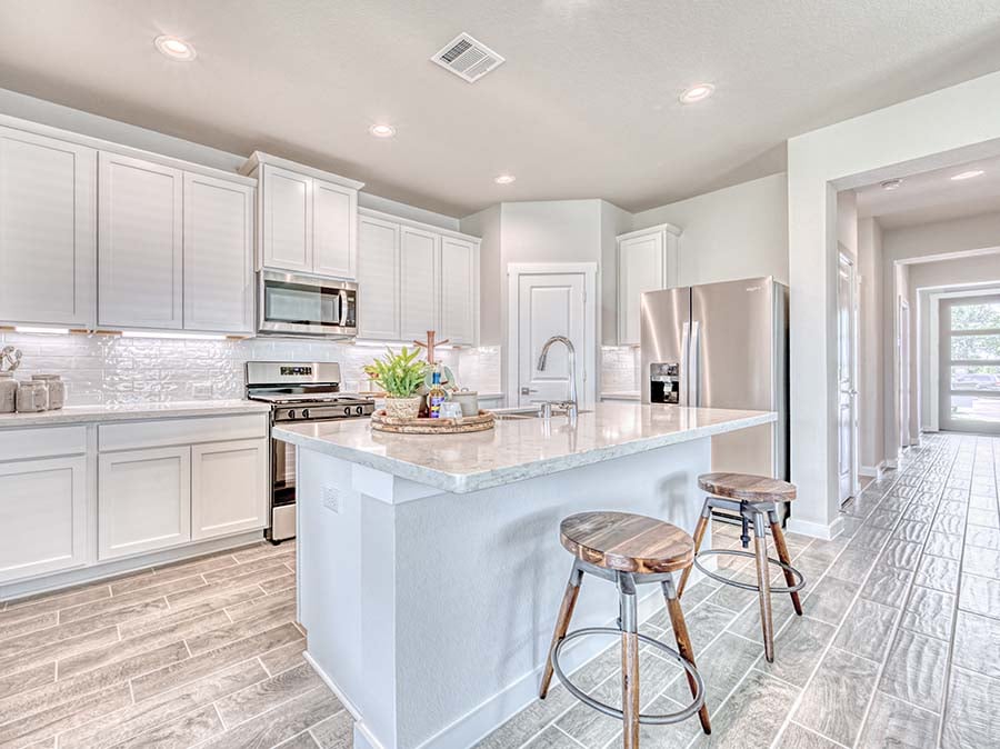 A kitchen with white cabinets.