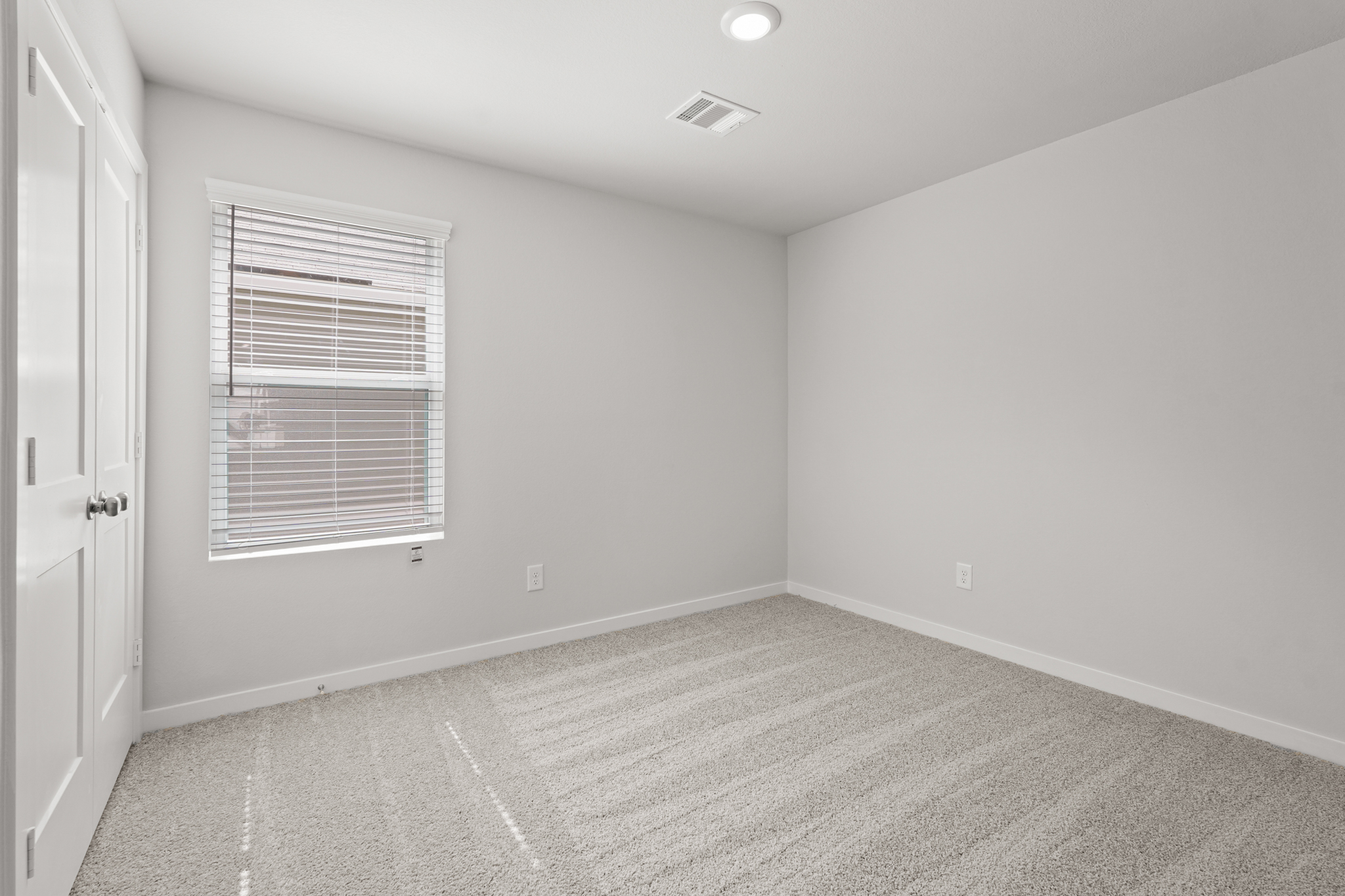 A room with a window and a door.