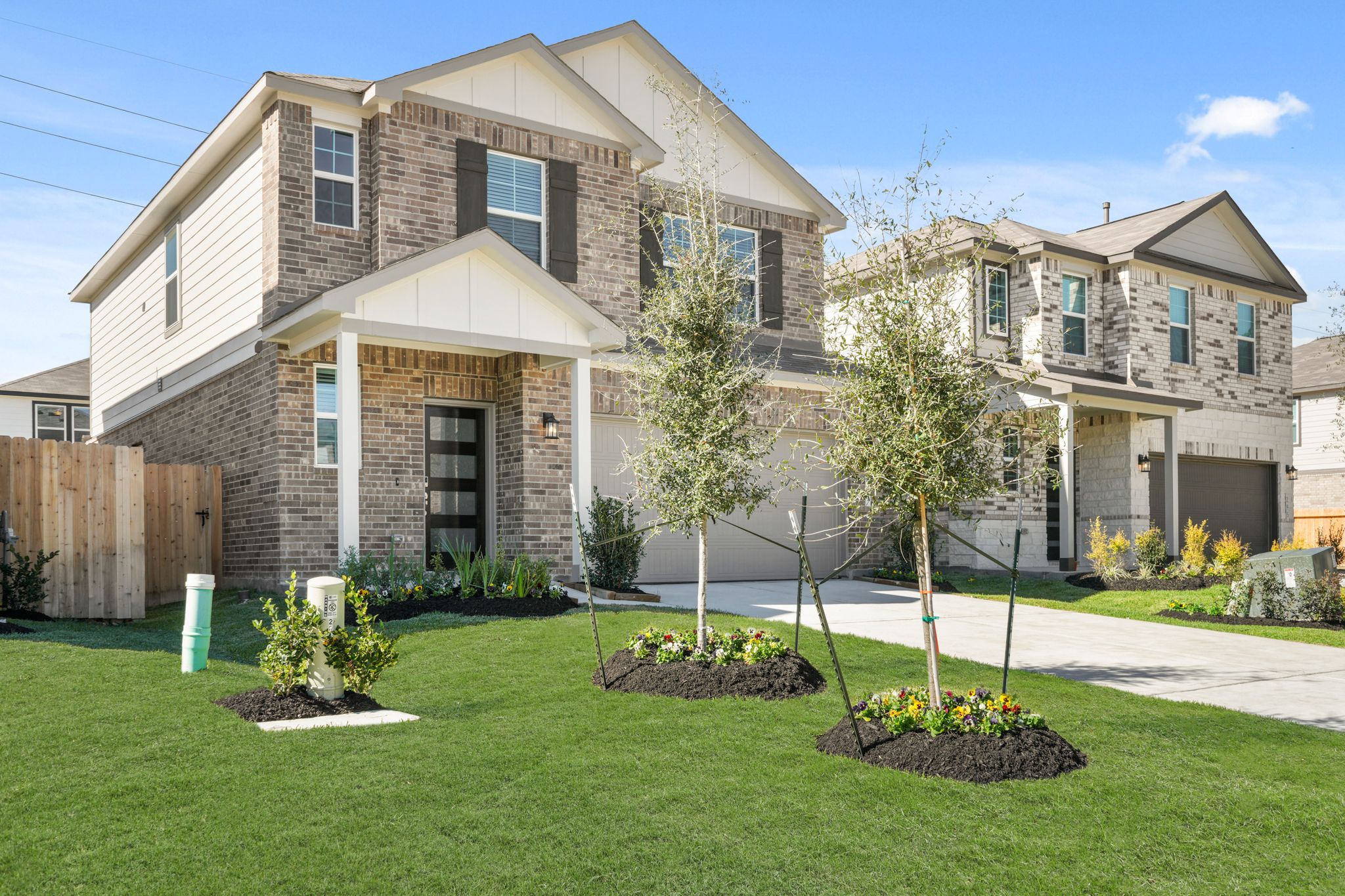 A large house with a yard and a fence.