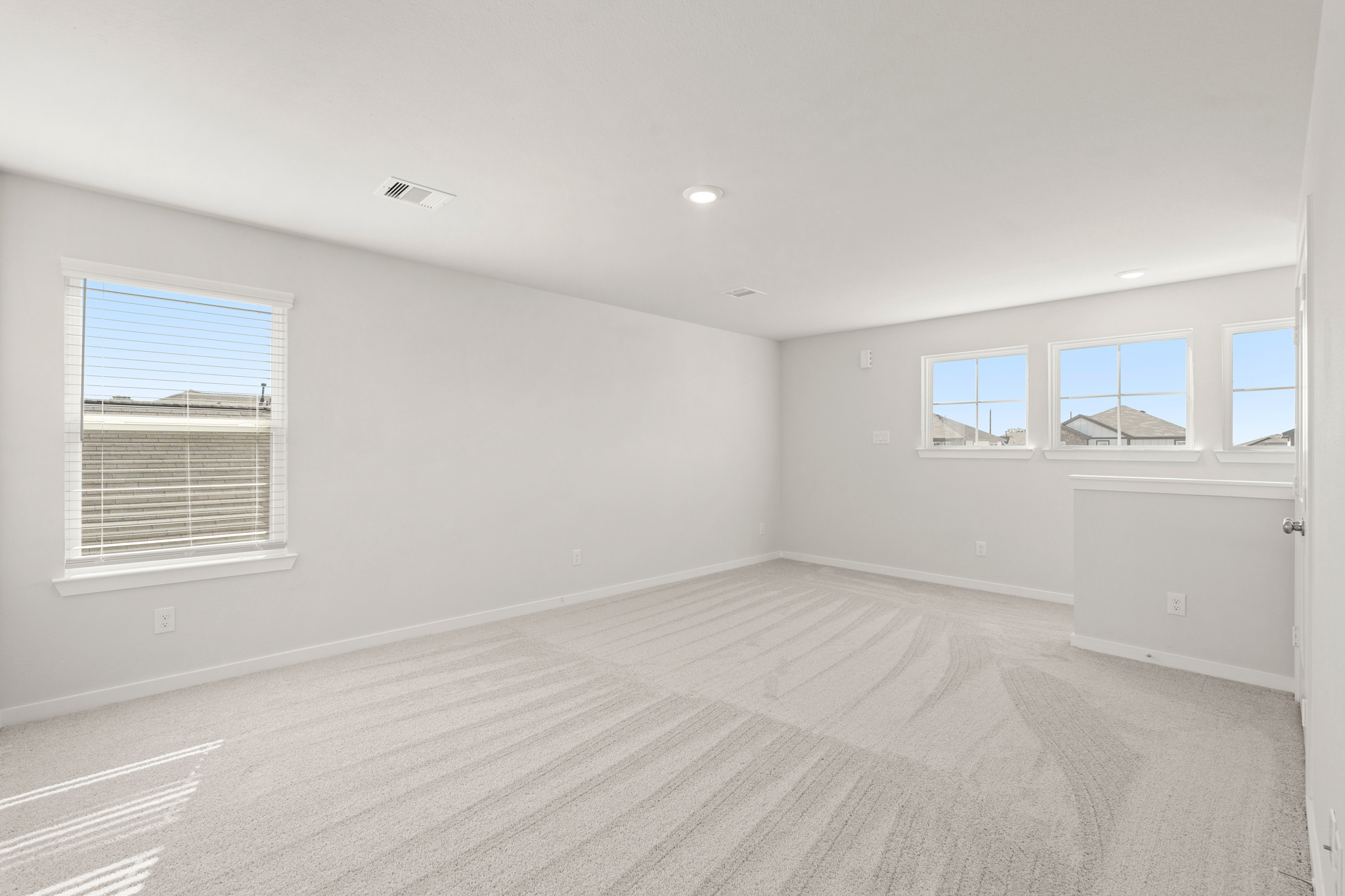 A room with a white floor and windows.
