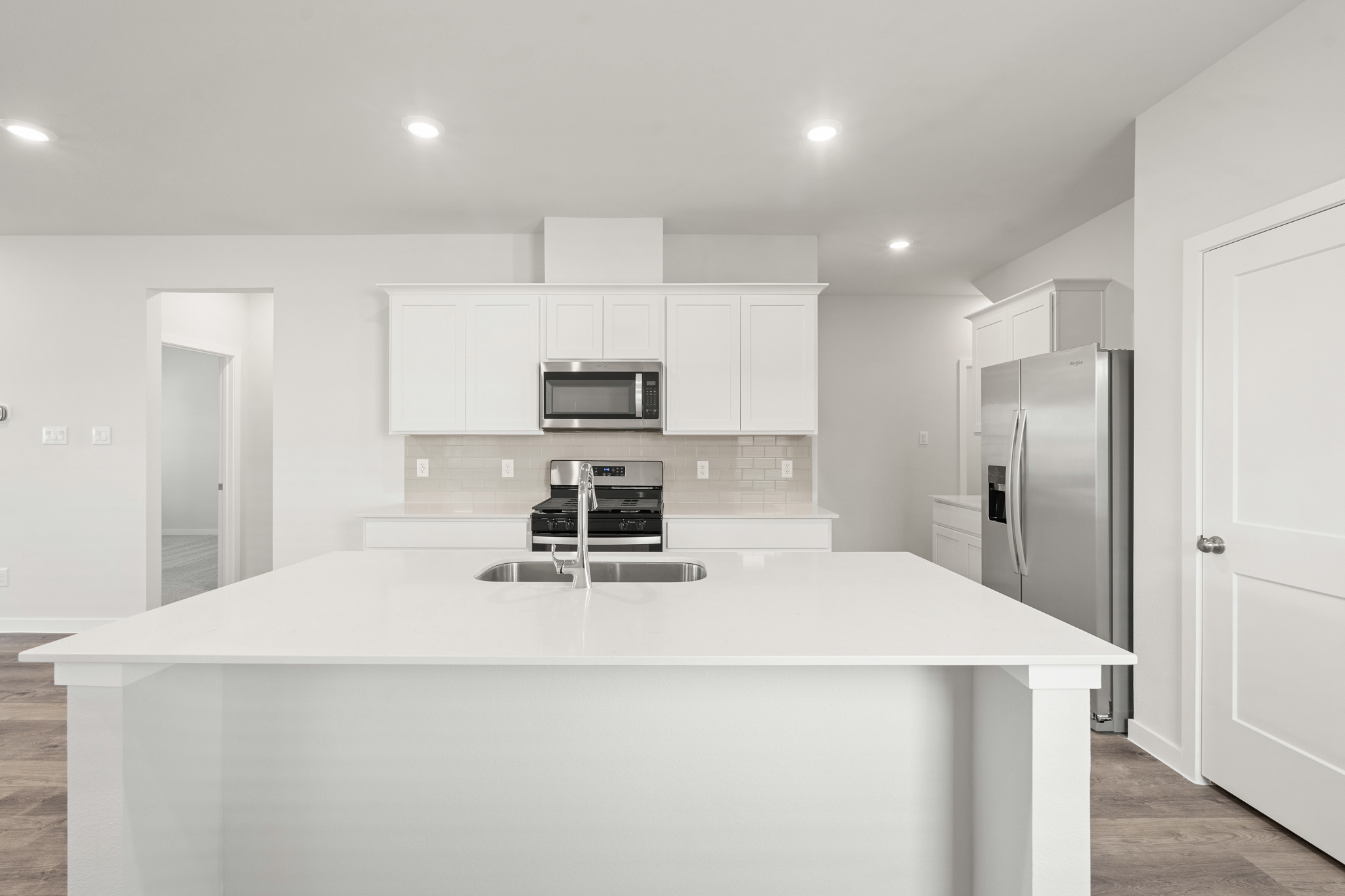 A kitchen with white cabinets.