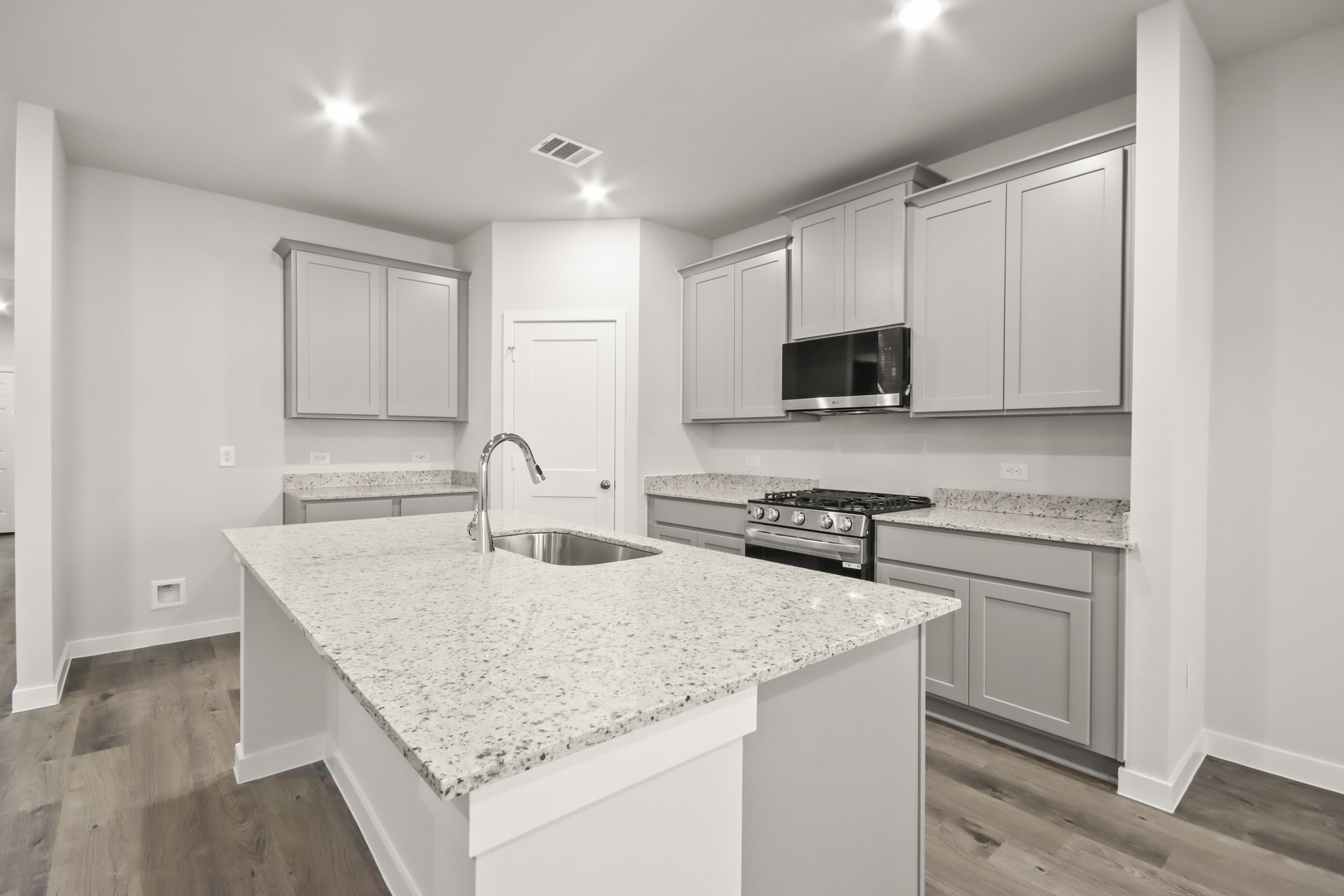 A kitchen with white cabinets.