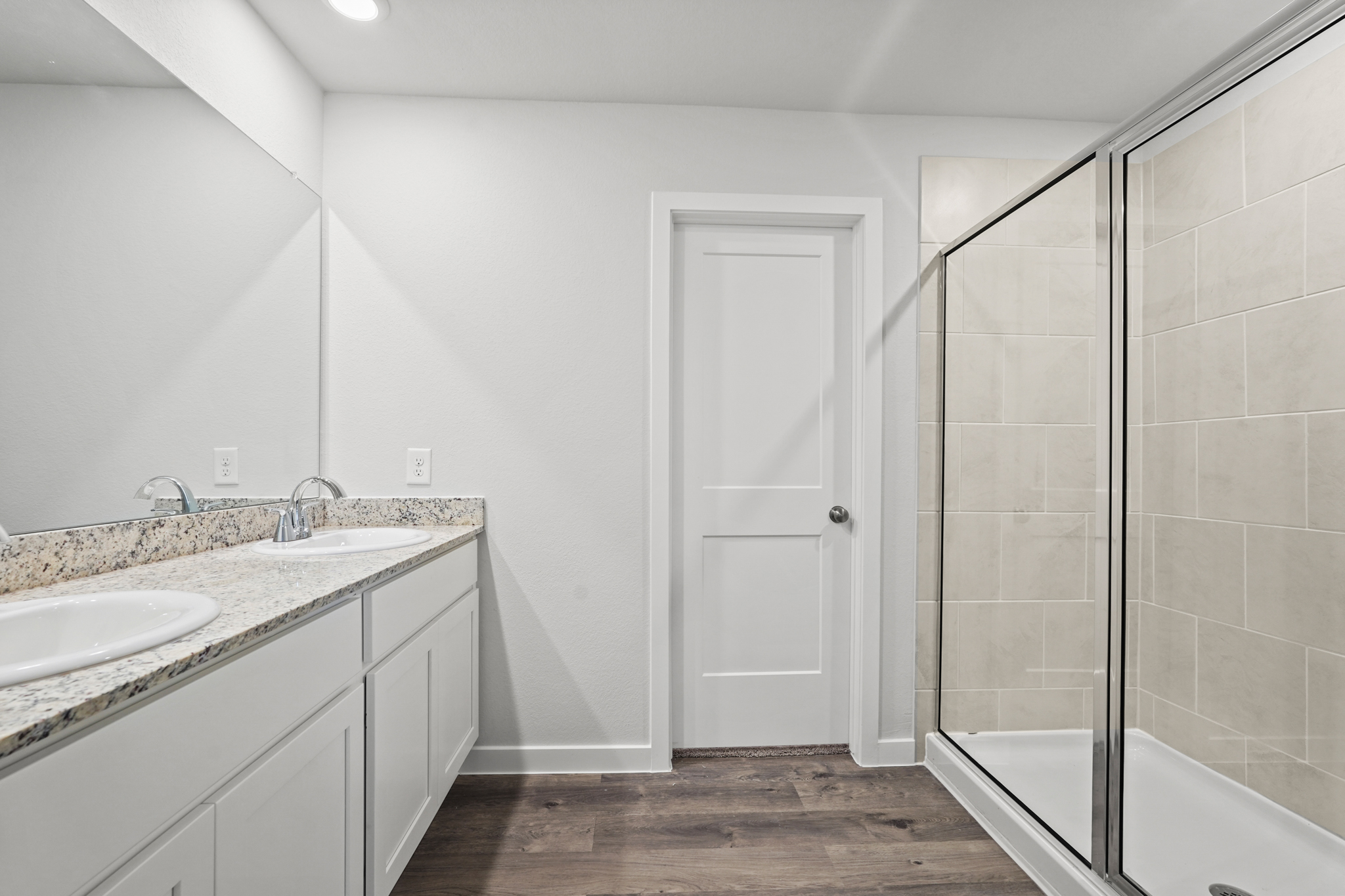 A bathroom with a shower and sink.