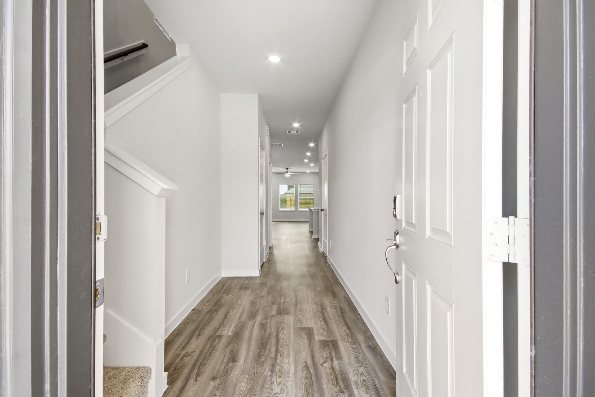 A hallway with white doors.