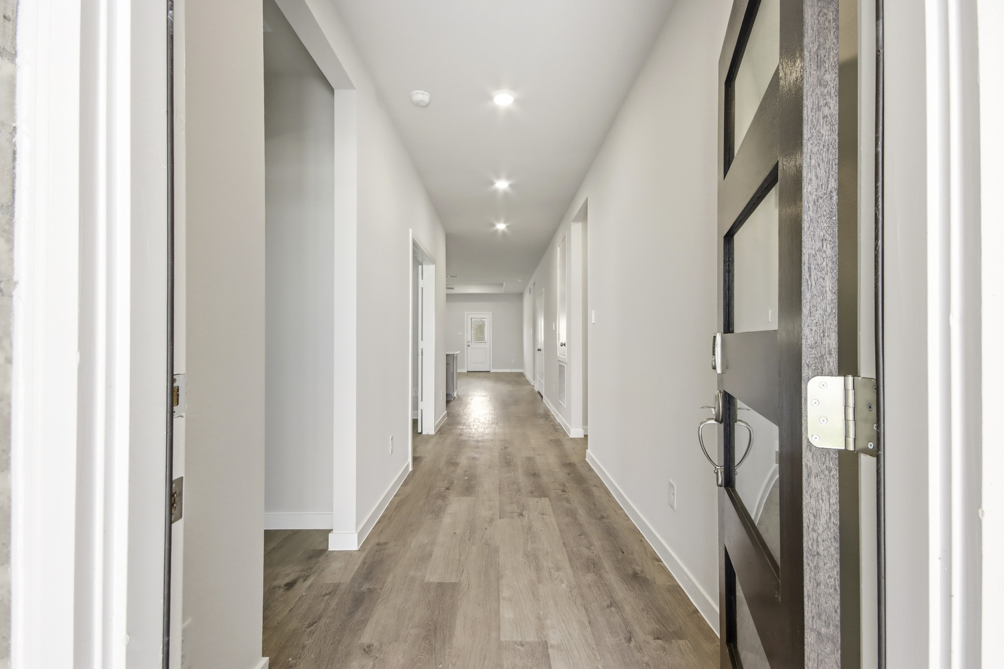 A long hallway with white walls.