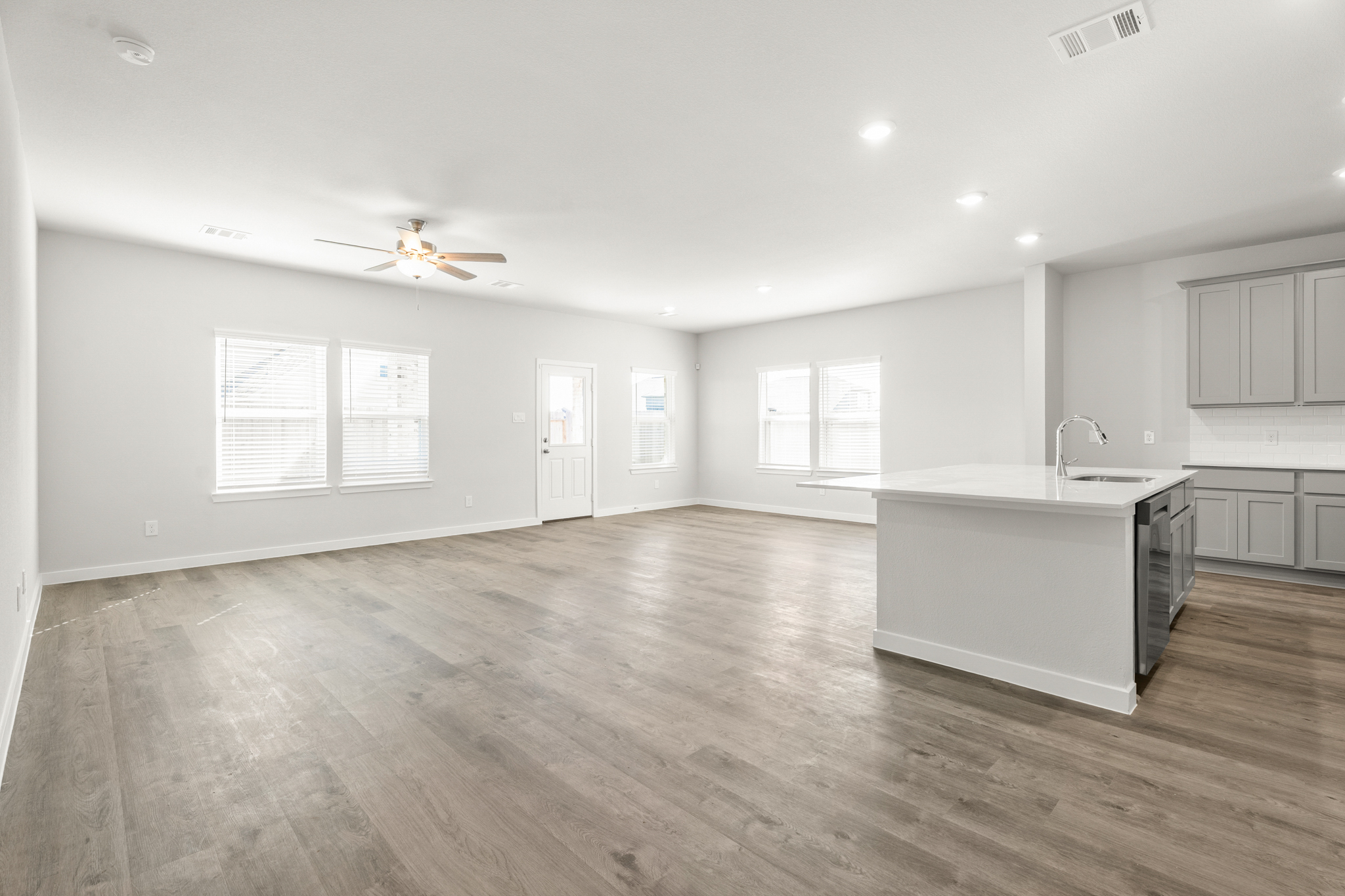 A kitchen with a wood floor.