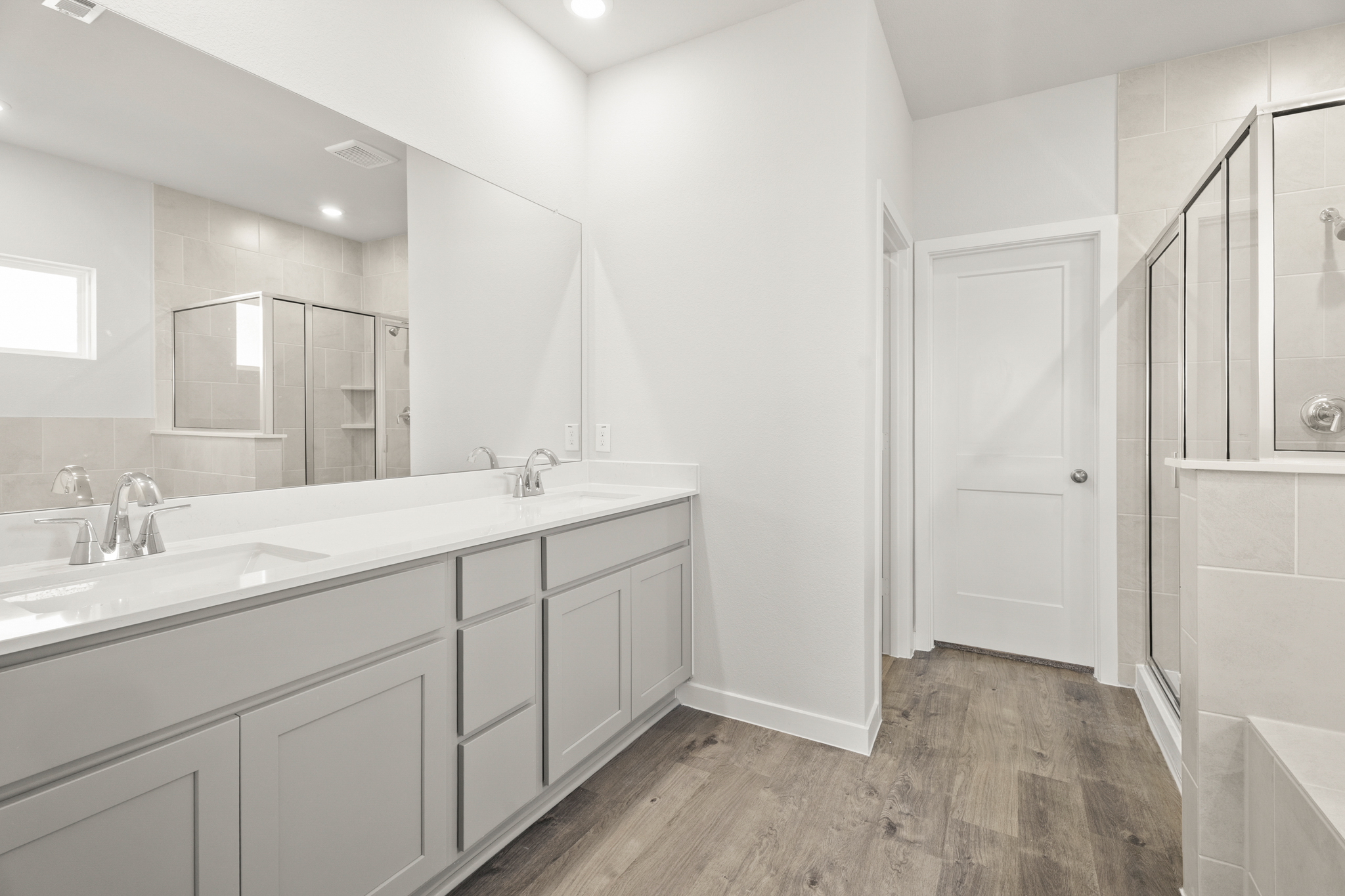 A bathroom with white cabinets.