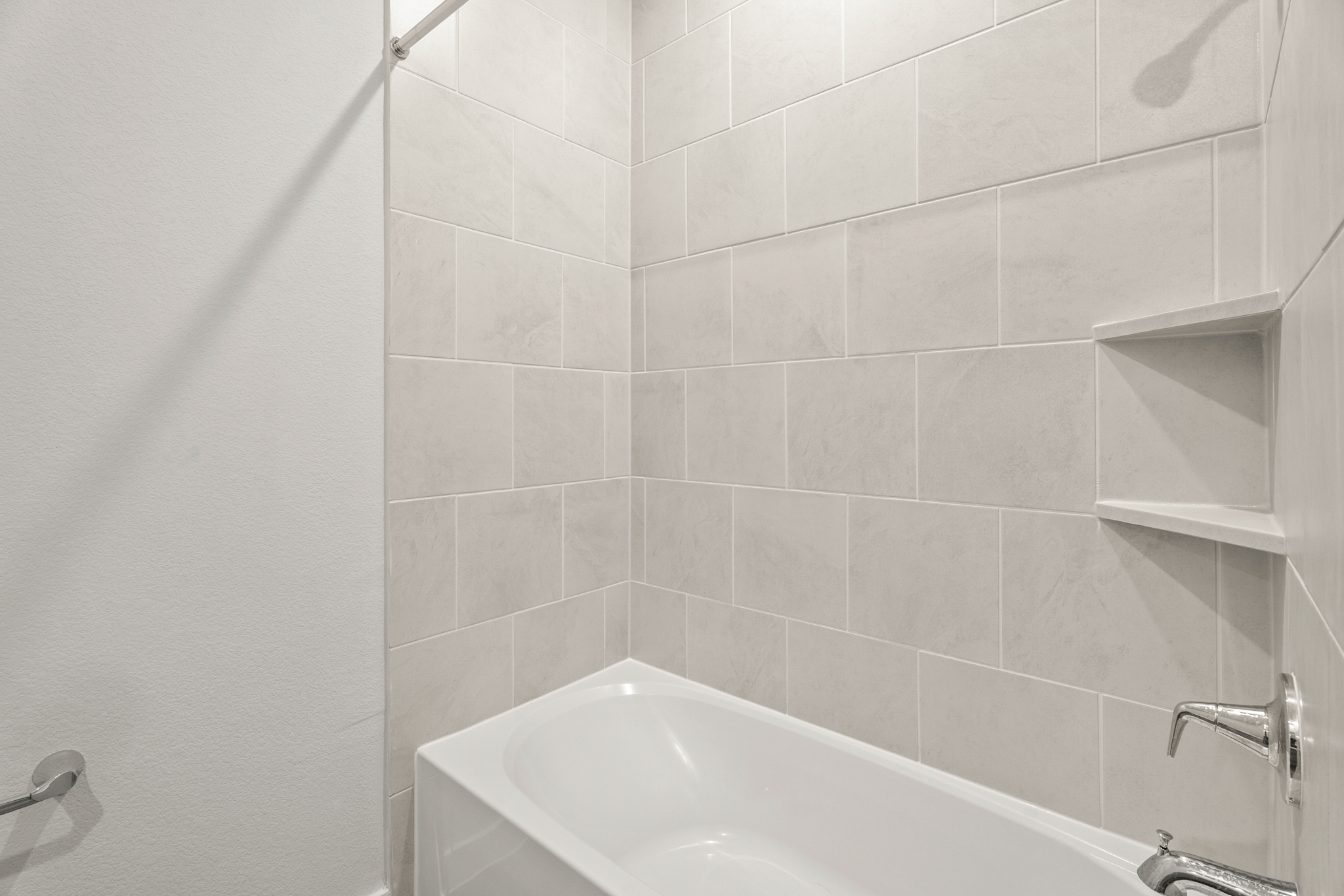 A bathtub in a bathroom.