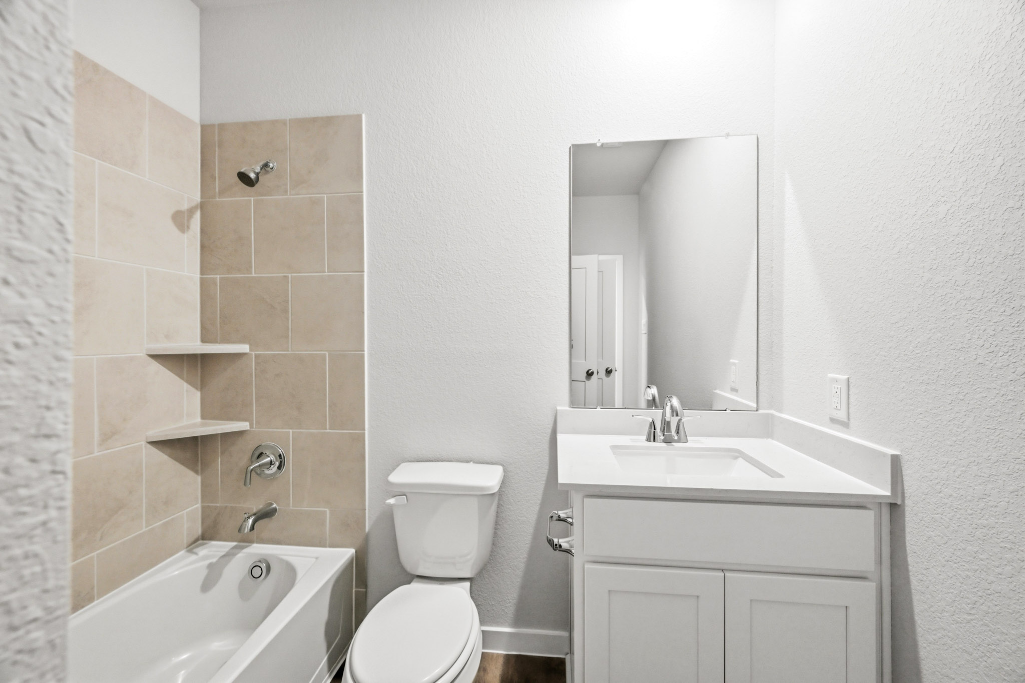 A bathroom with a toilet sink and bathtub.