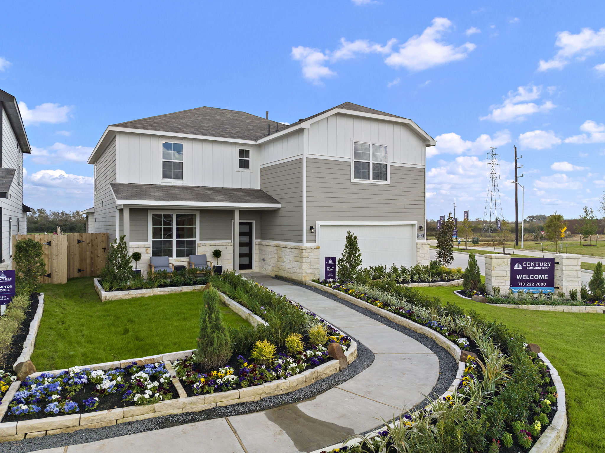 A white house with a sign in front of it.