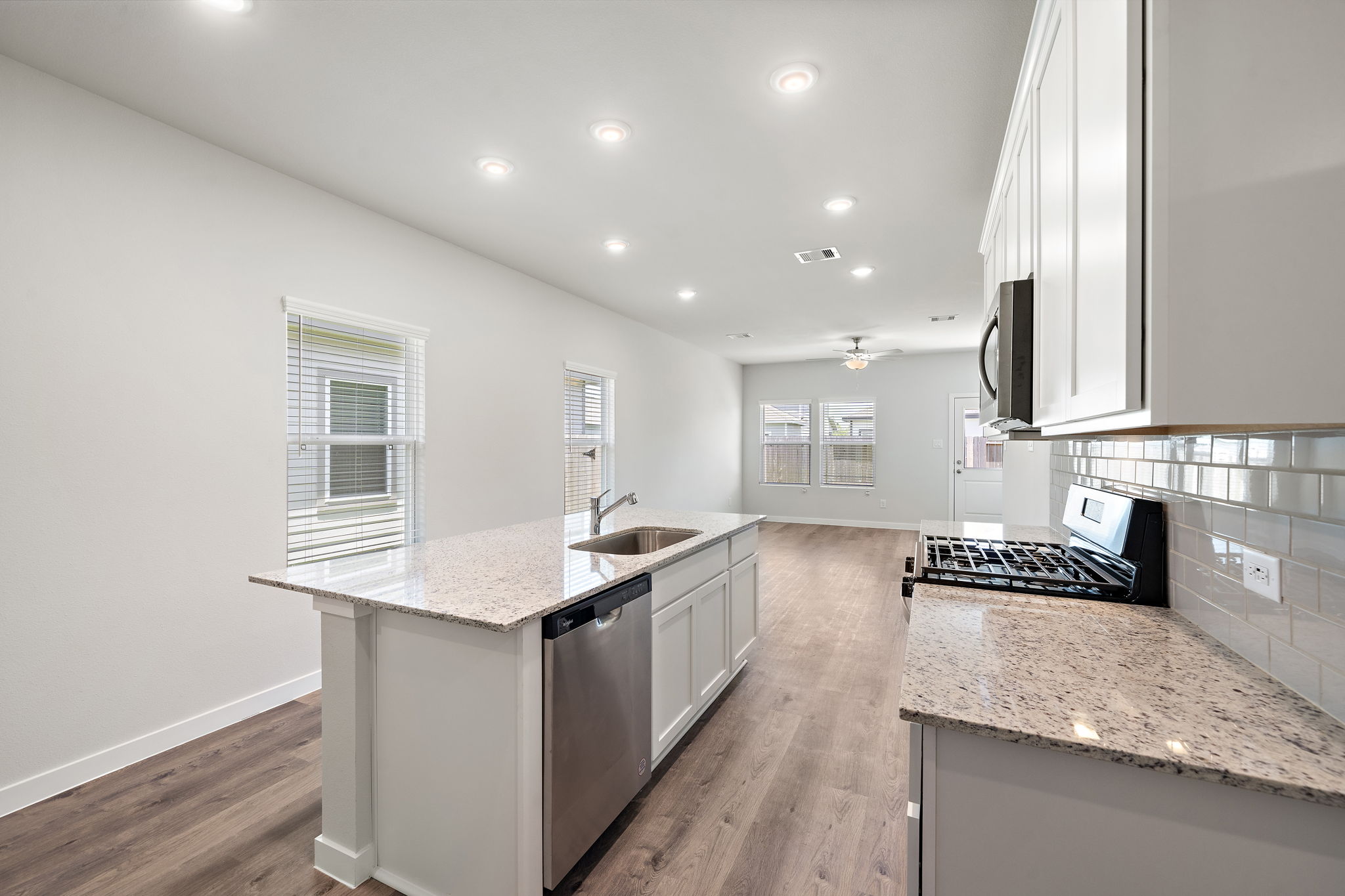 A kitchen with white cabinets.