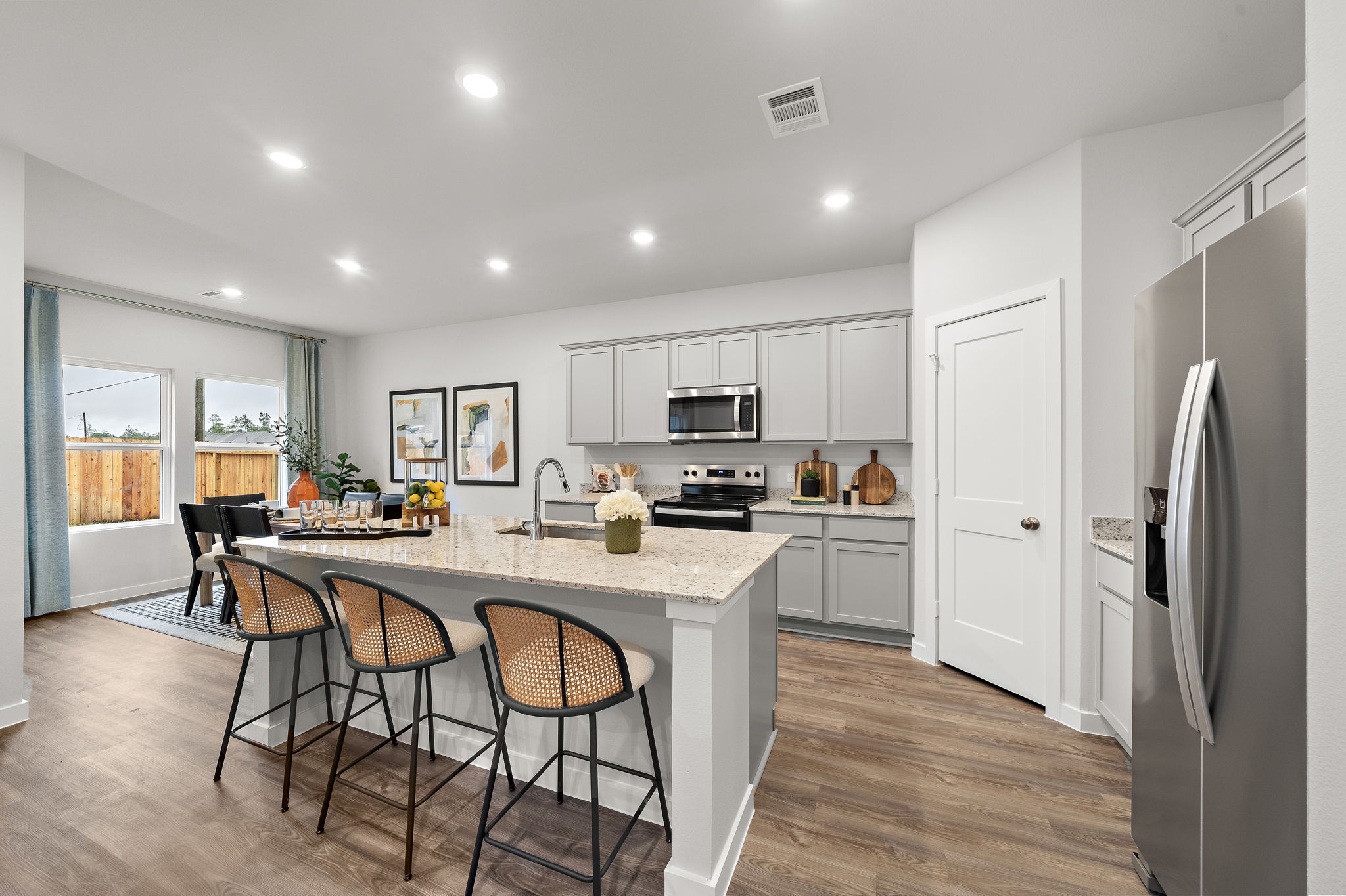 A kitchen with a dining table and chairs.