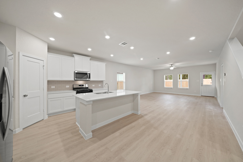 A large kitchen with white cabinets.