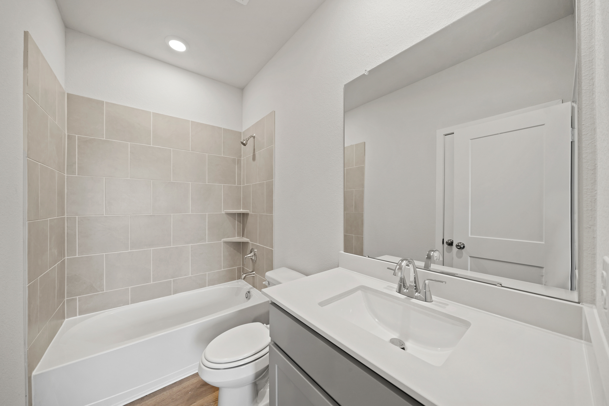 A bathroom with a tub sink and toilet.