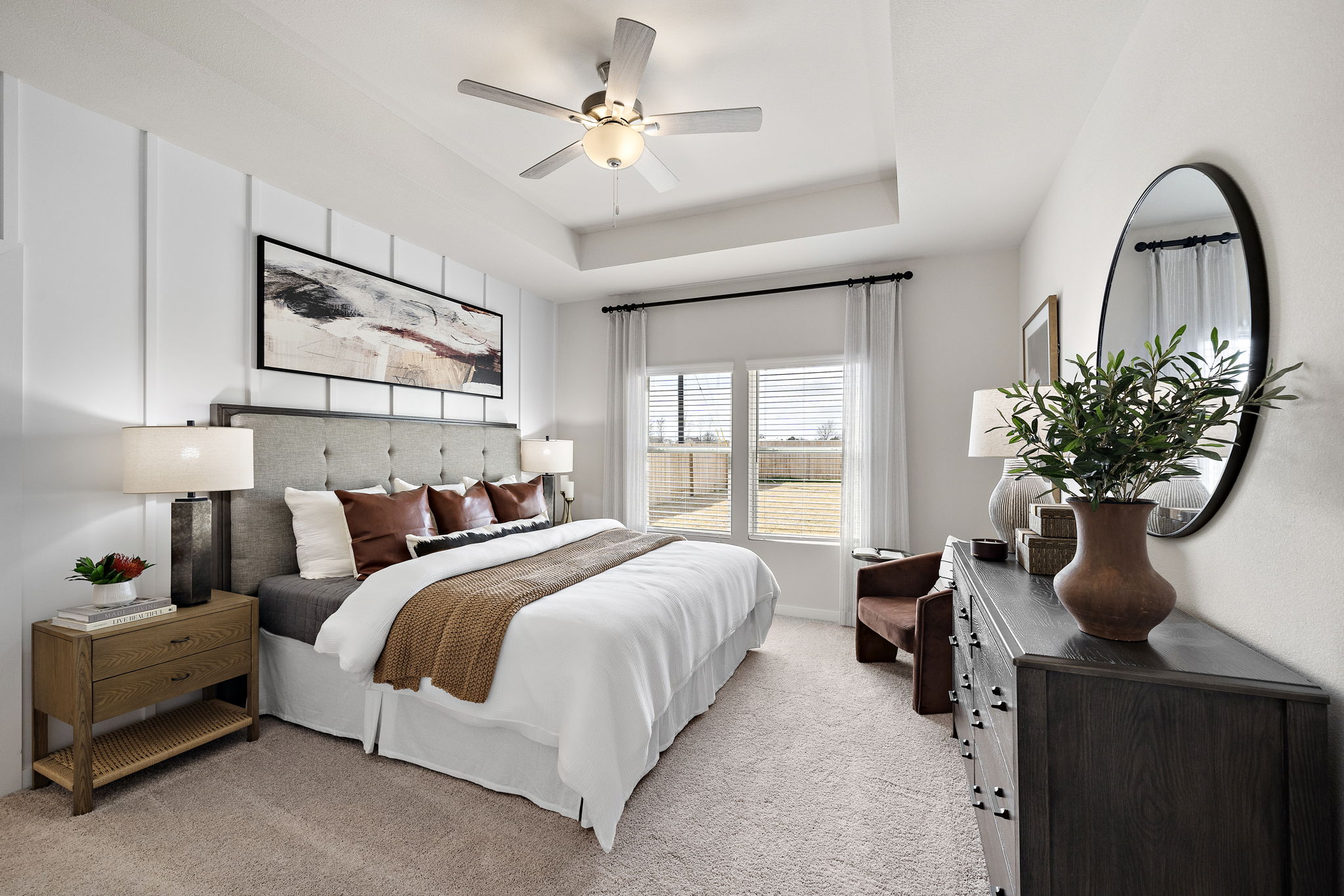 A bedroom with a large mirror.