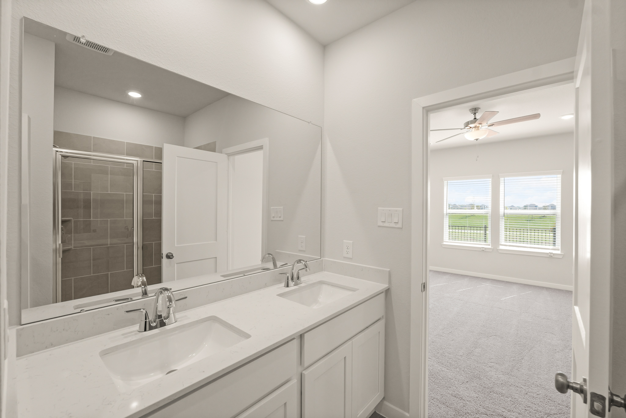 A bathroom with a large mirror.