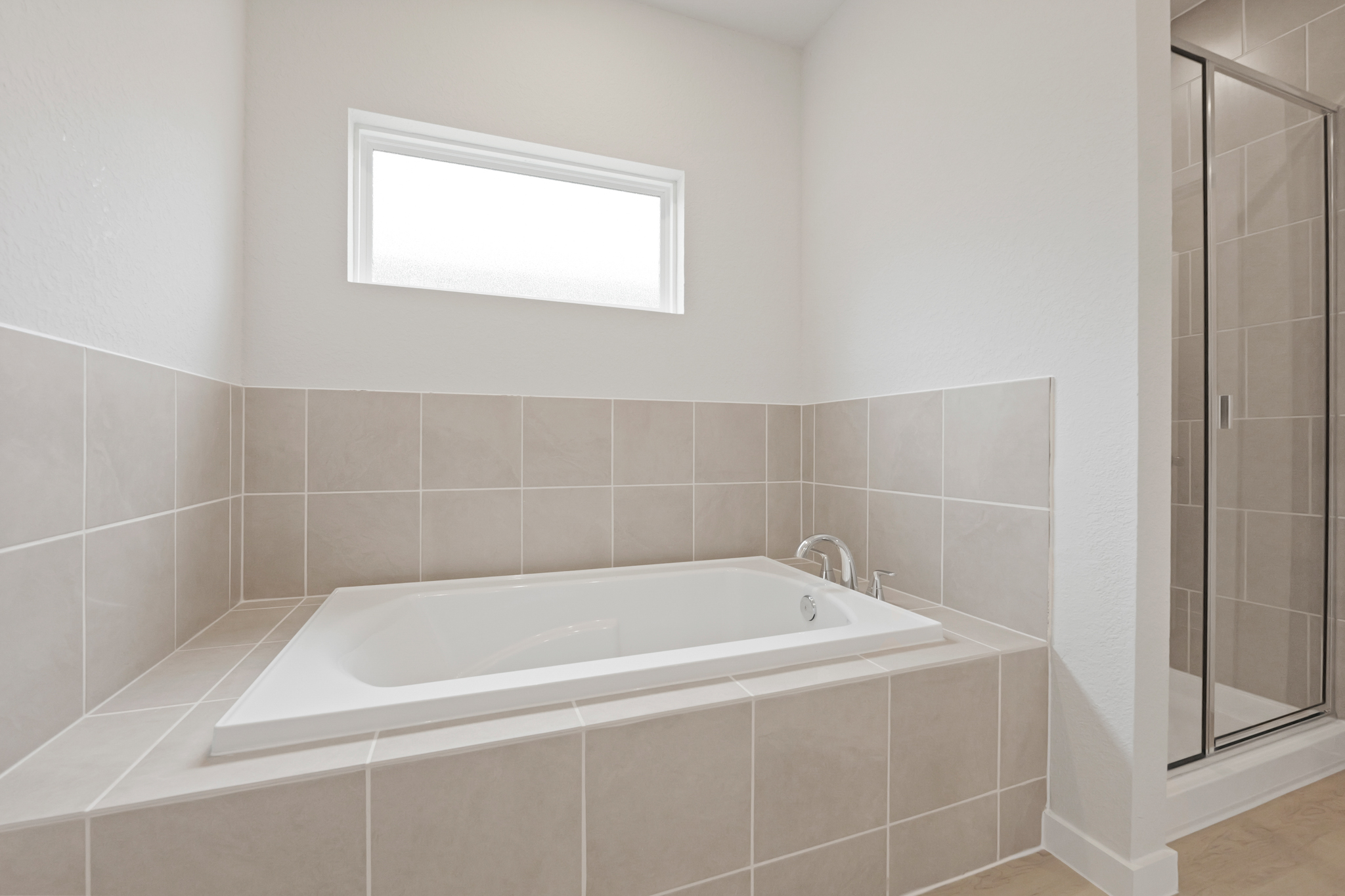 A bathtub in a bathroom.