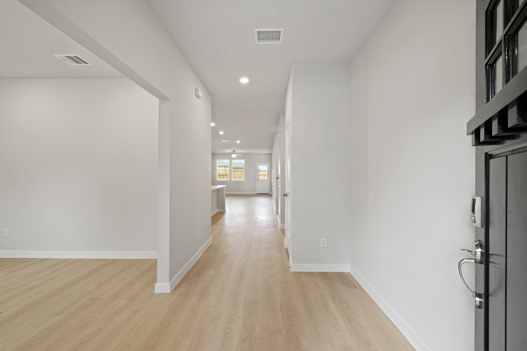 A long hallway with white walls.