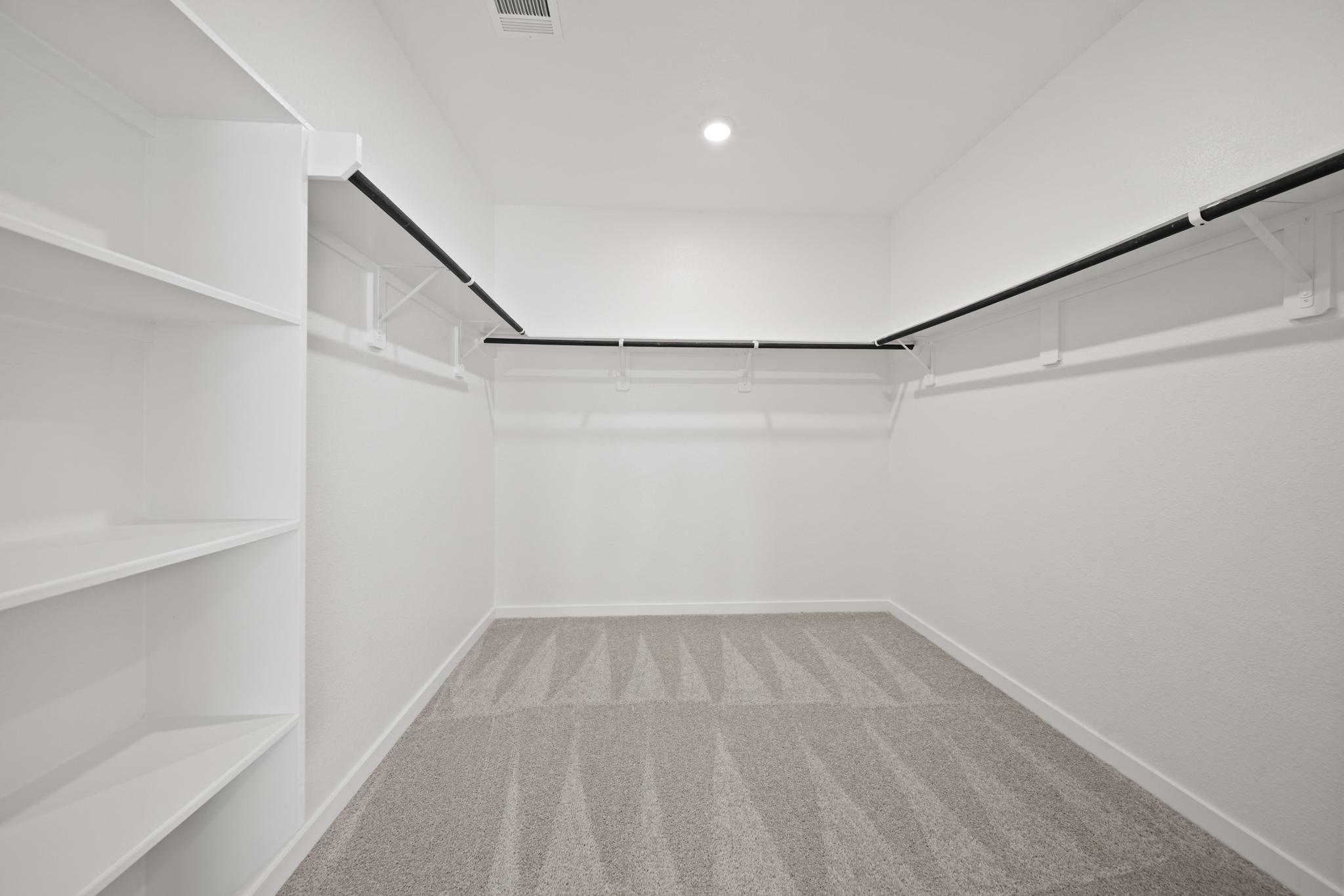 A white room with a staircase.