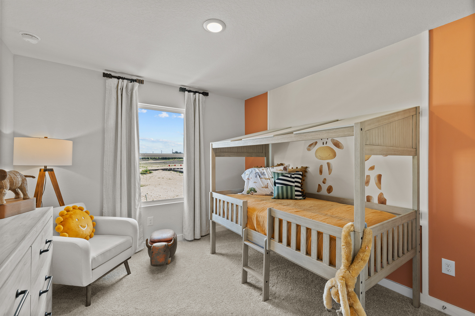 A bedroom with a bed and a chair.