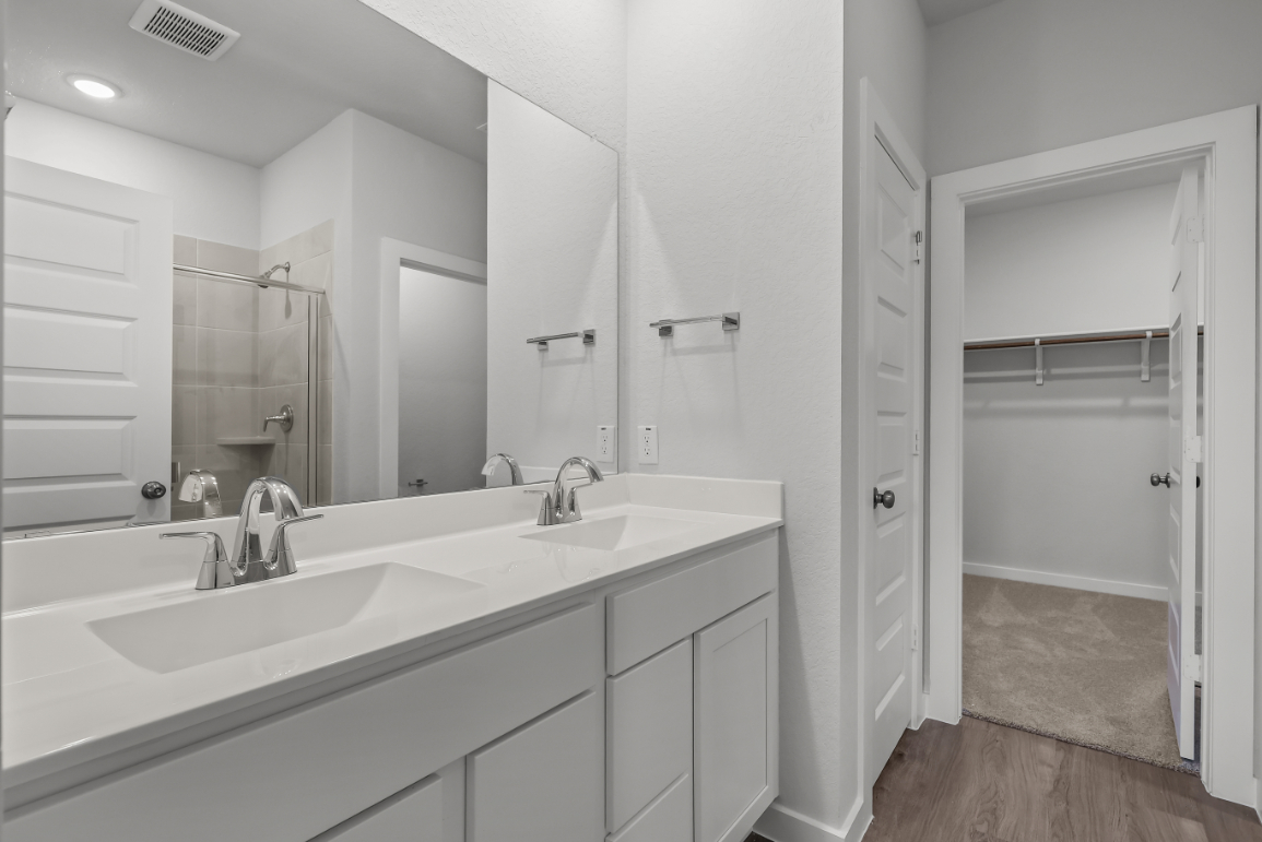 A bathroom with a large mirror.