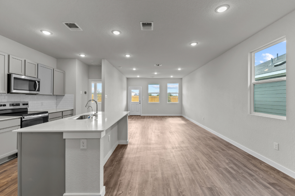 A kitchen with white cabinets.