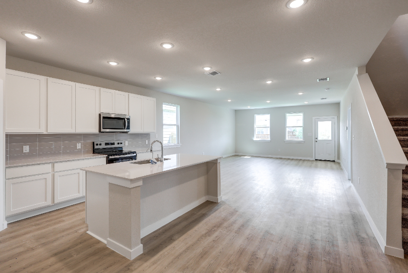 A kitchen with white cabinets.