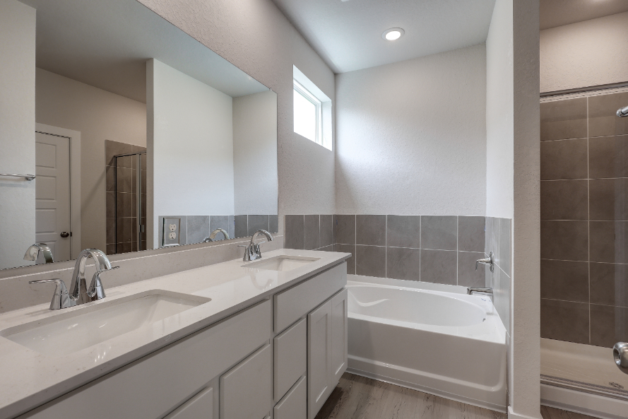 A bathroom with a tub sink and a bathtub.