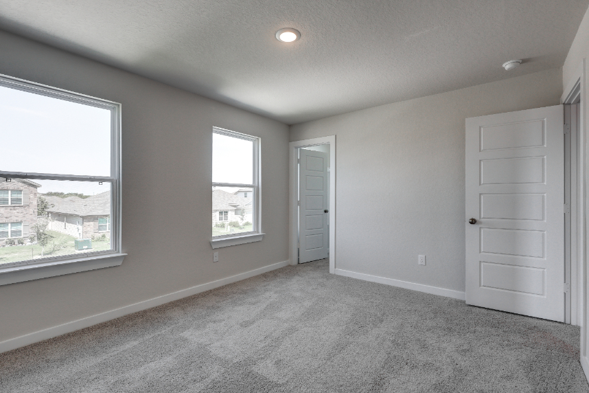 A room with a door and windows.