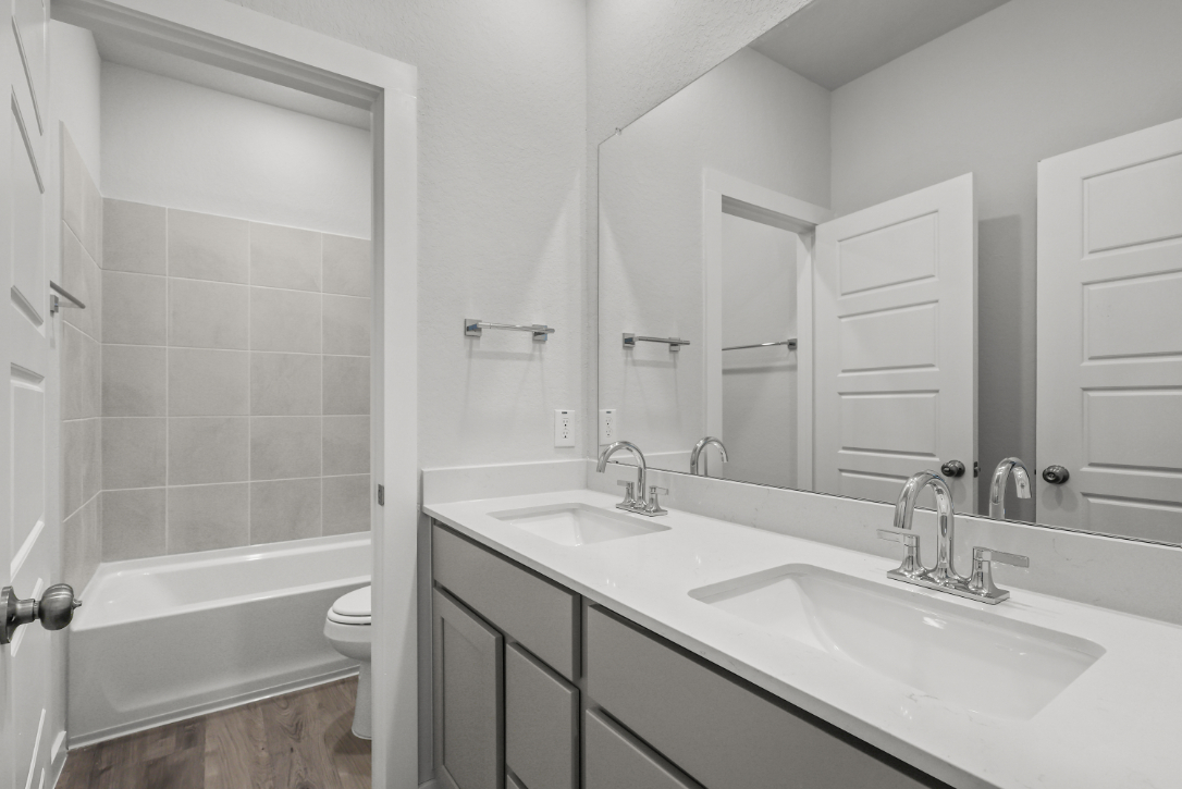 A bathroom with a tub sink and toilet.