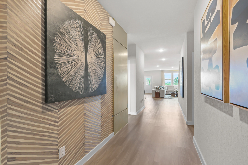 A long hallway with art on the walls.