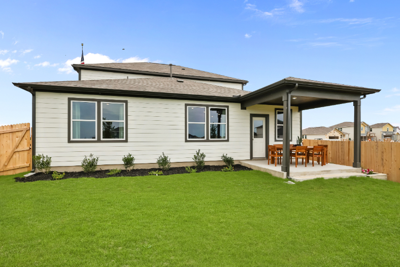 A house with a lawn and a fence.