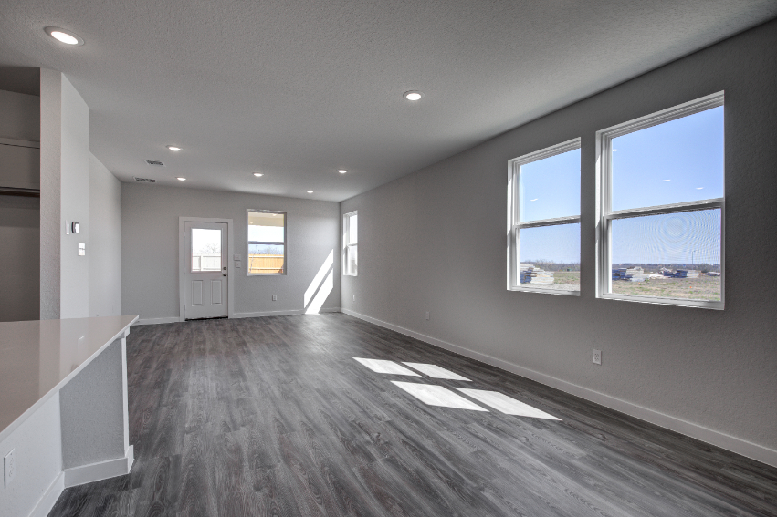 A room with a large window and a large white floor.