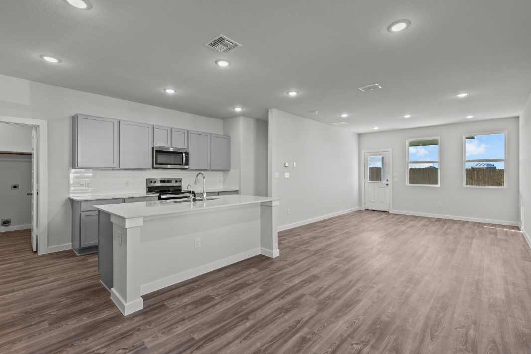 A large kitchen with white cabinets.