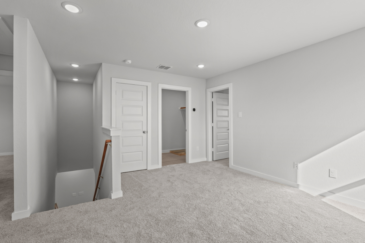 A hallway with white doors.