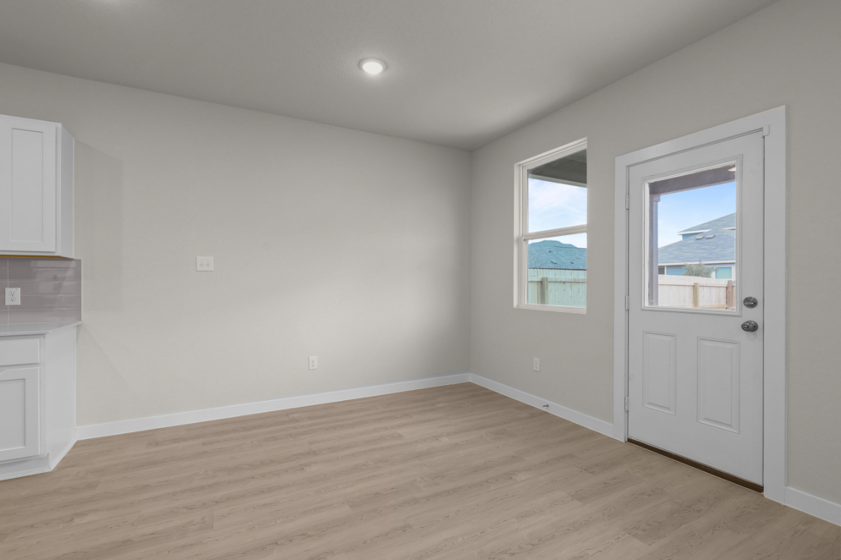 A room with a wood floor and white walls.