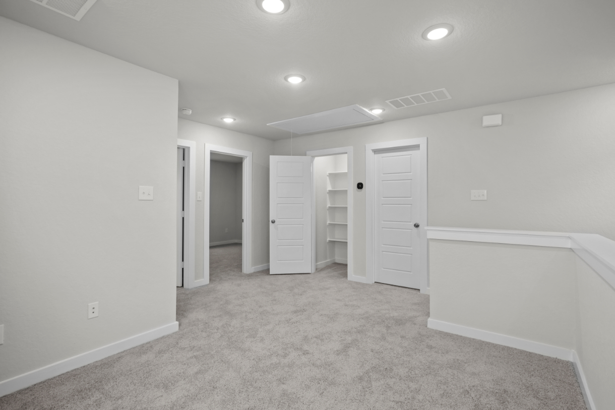 A room with white walls and white cabinets.
