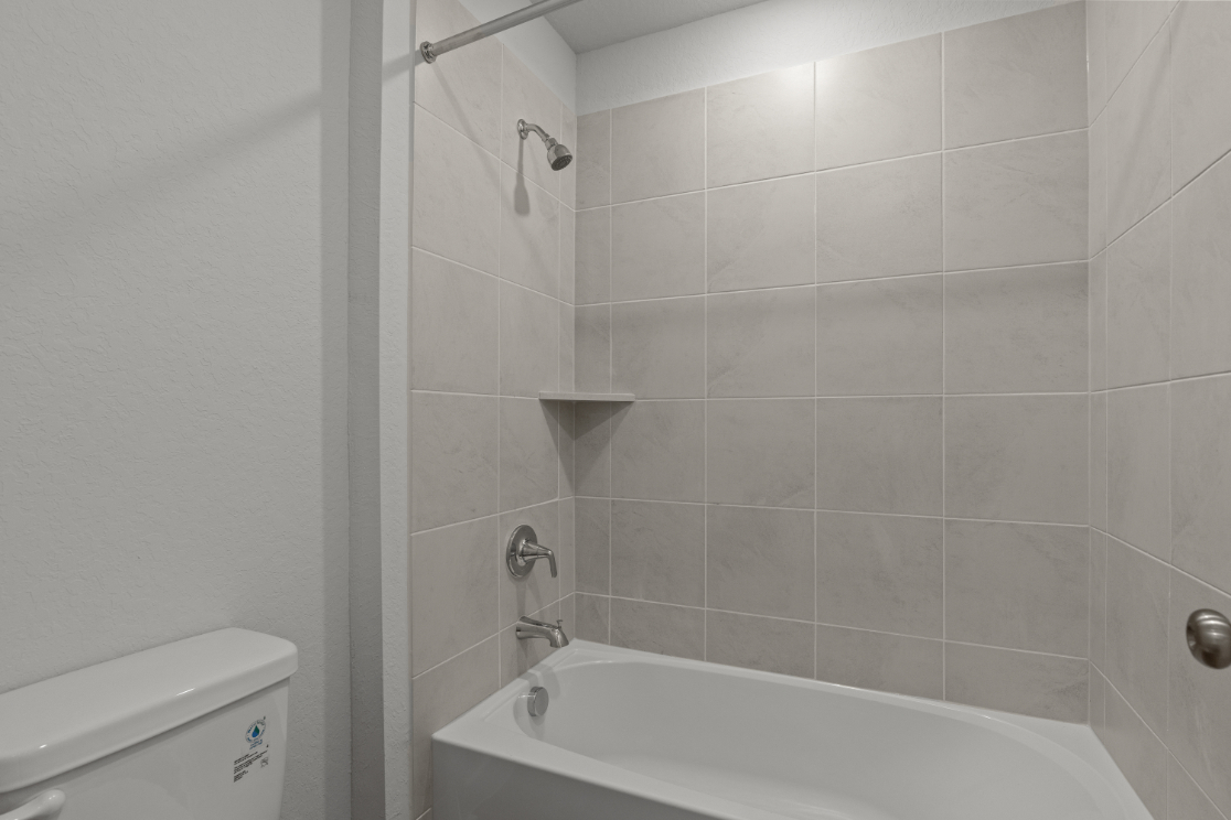 A bathtub in a bathroom.