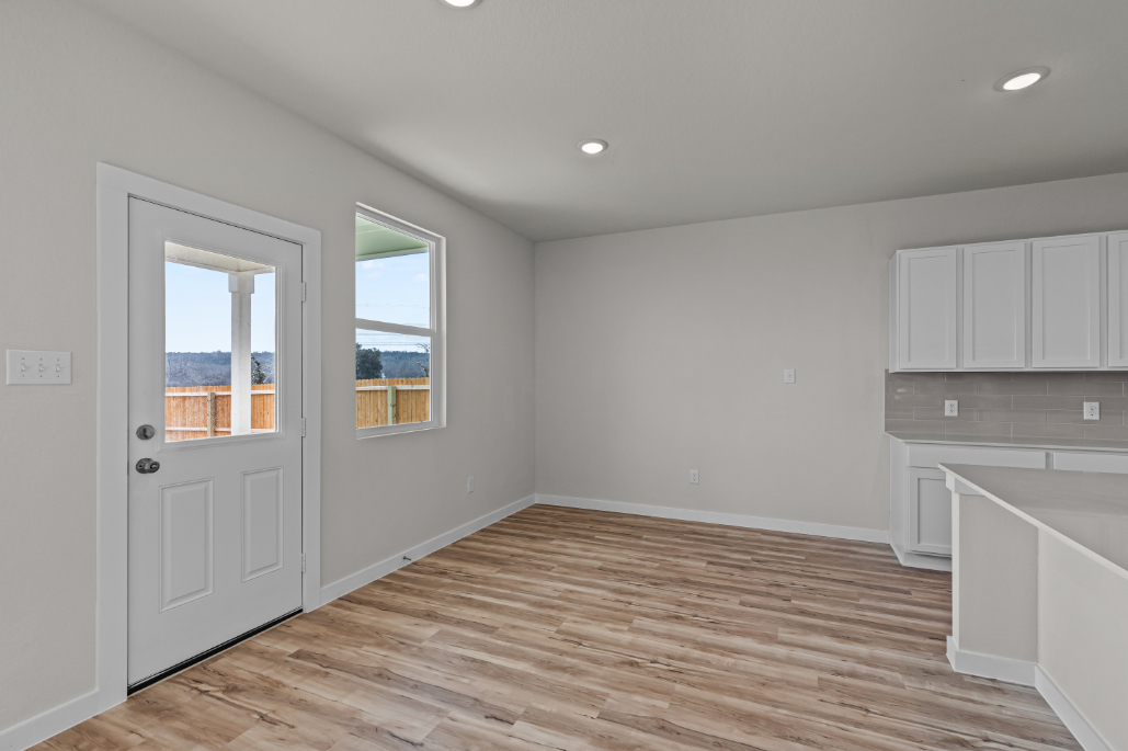 A kitchen with white cabinets.