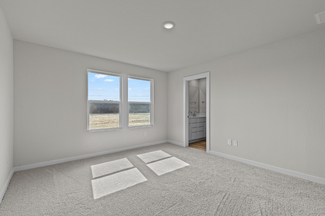 A room with a window and rugs.