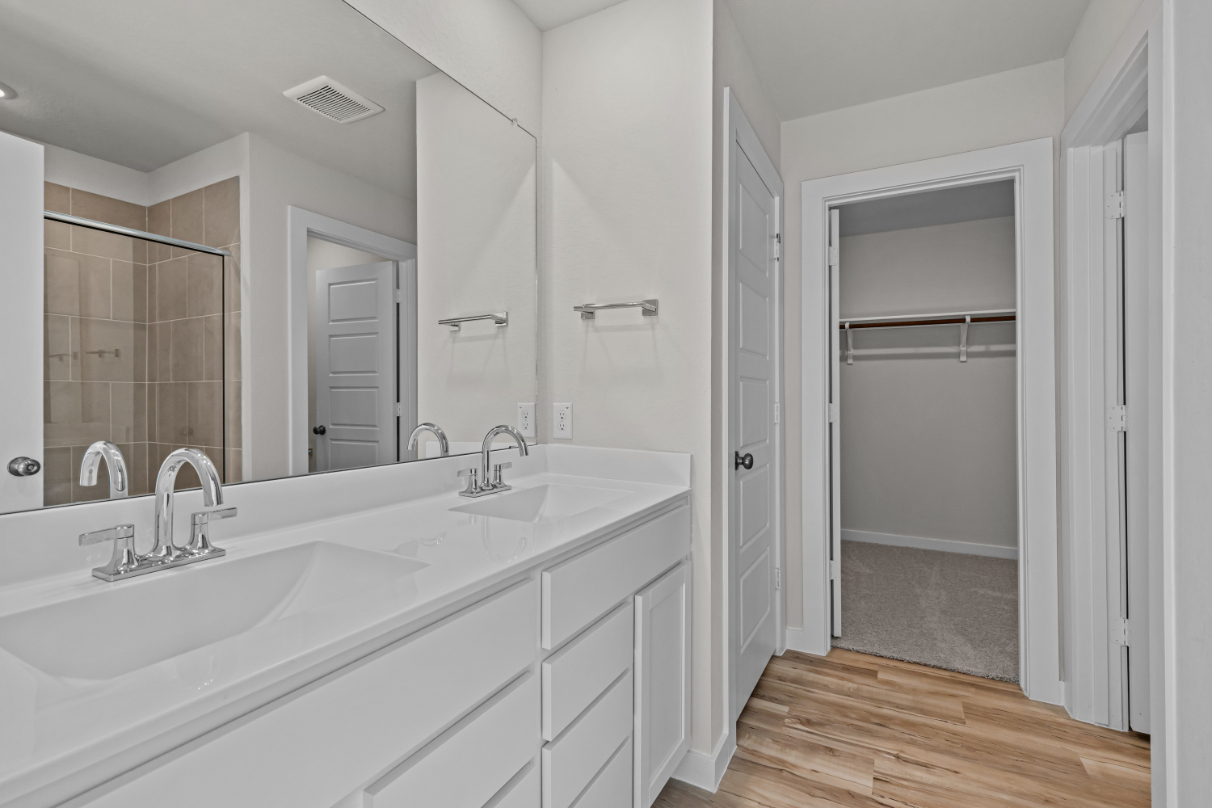 A bathroom with a large mirror.