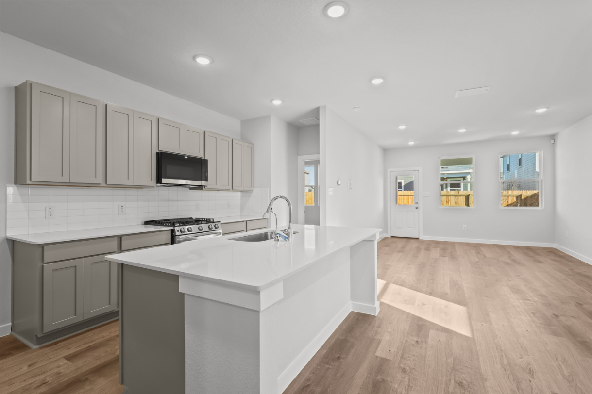 A kitchen with white cabinets.