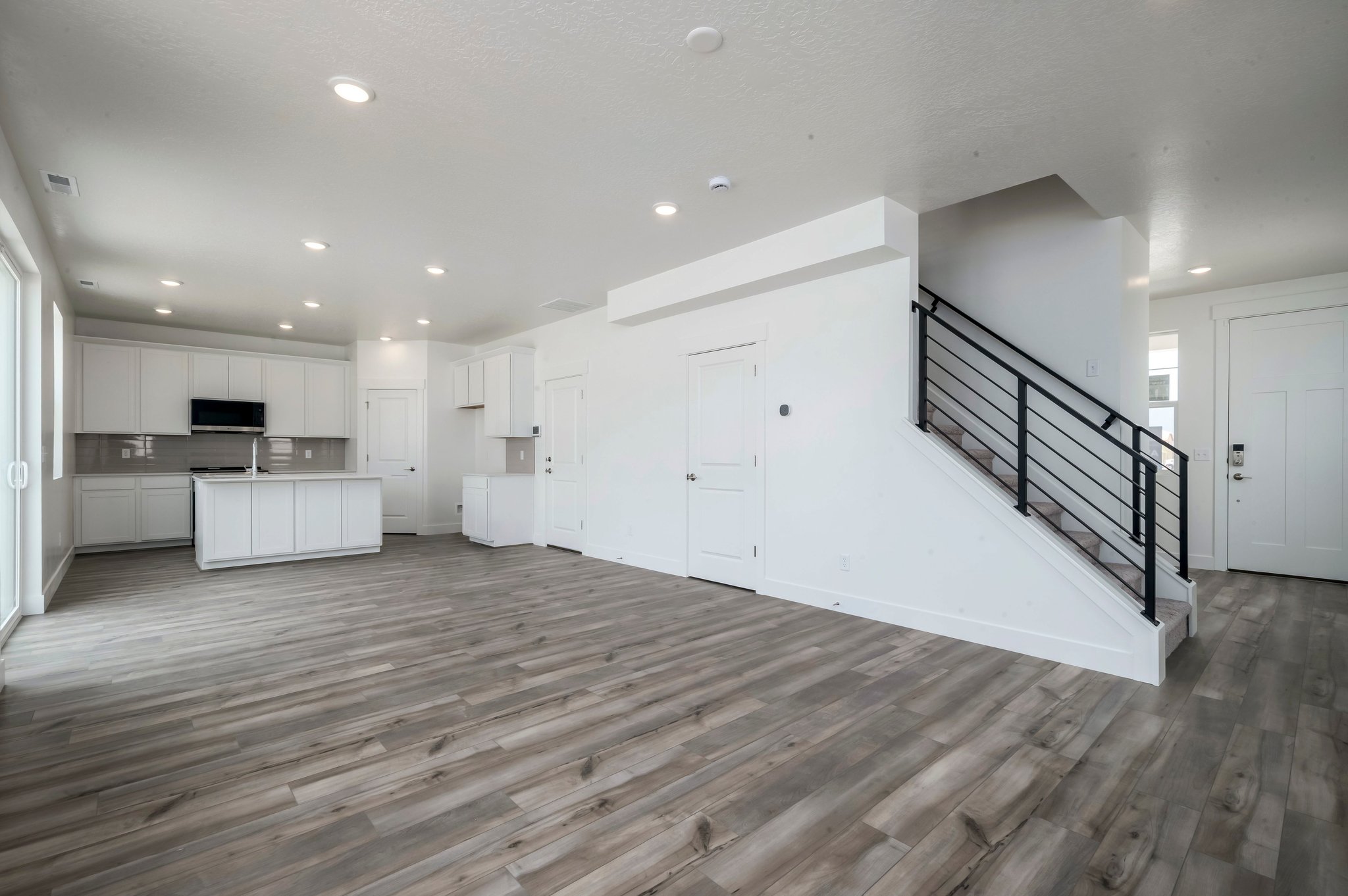 A large empty room with white cabinets.