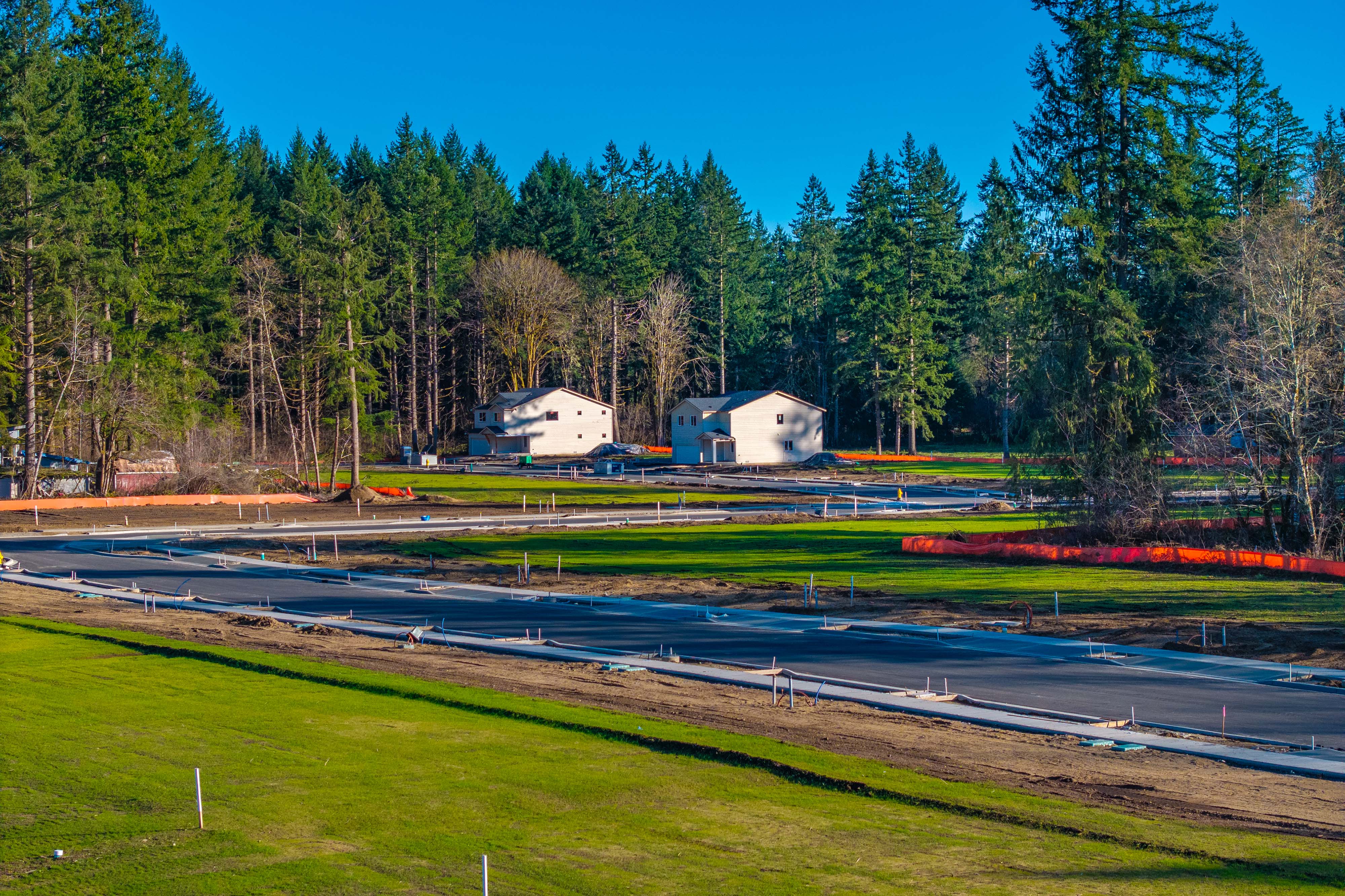 A pond with a house in the background.