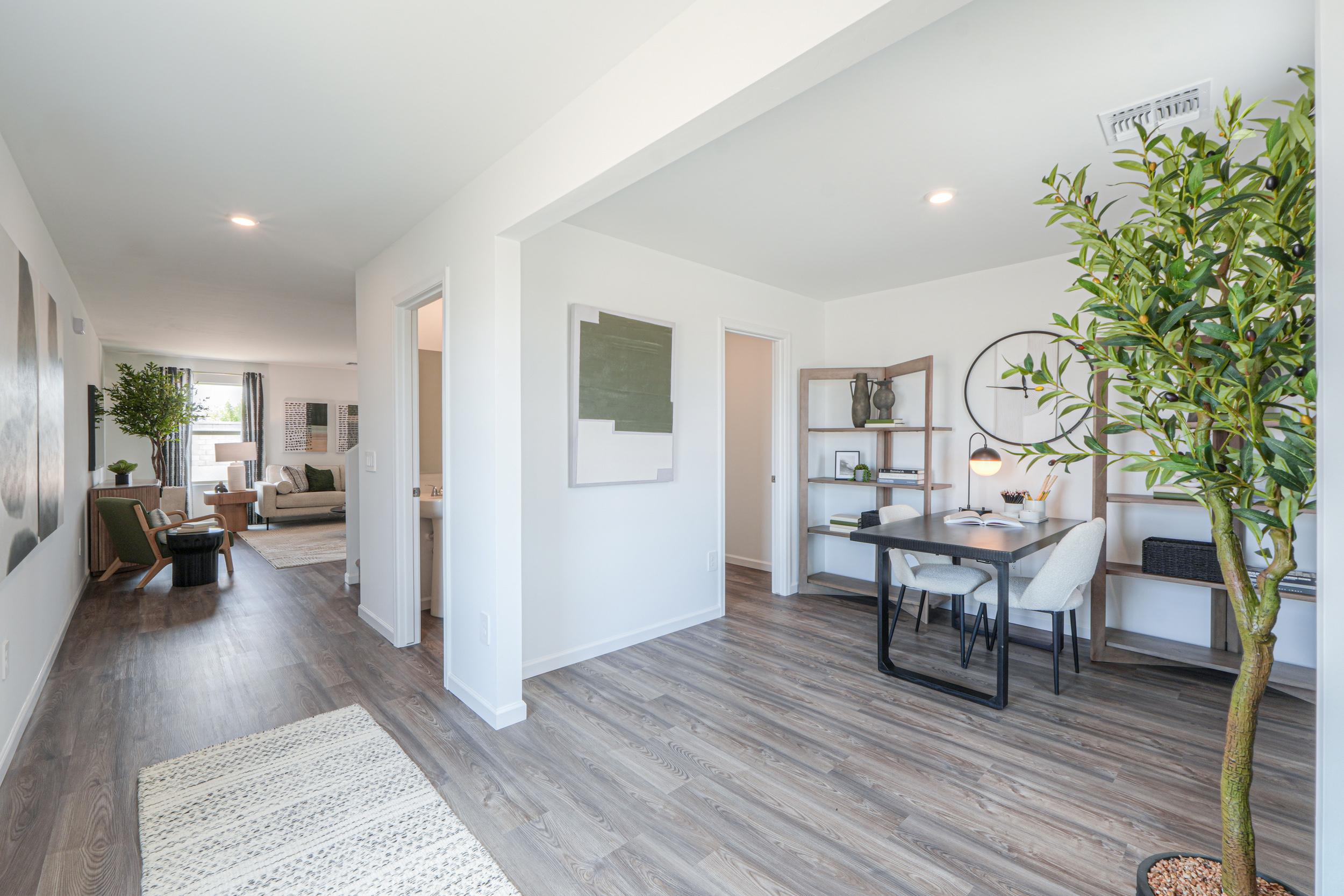 A living room with a table and chairs.