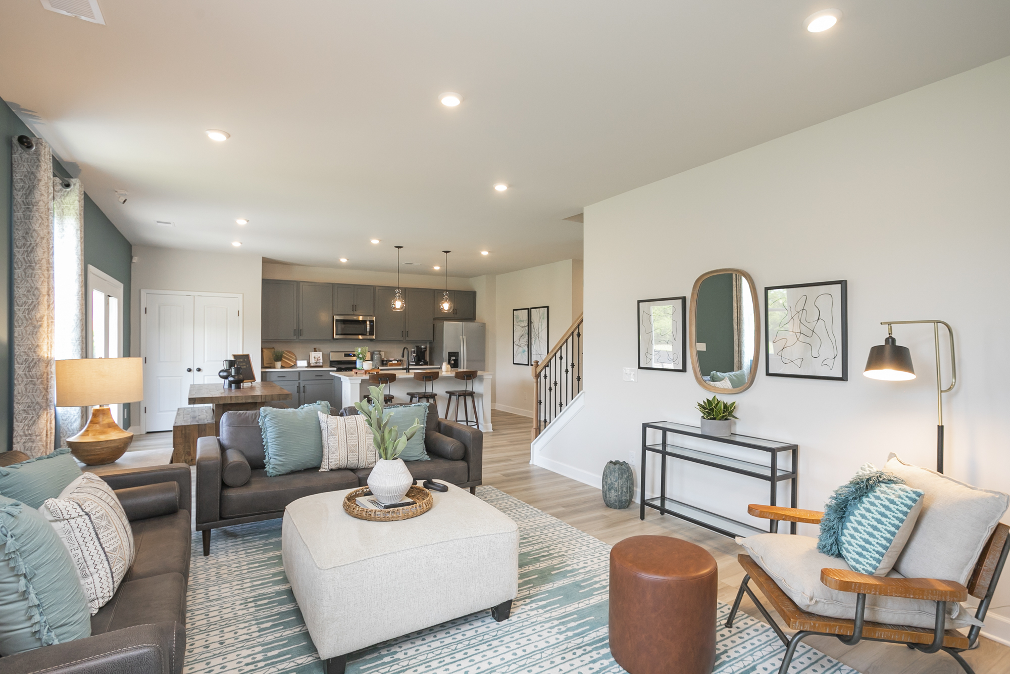 A living room with a large chandelier and a large mirror.
