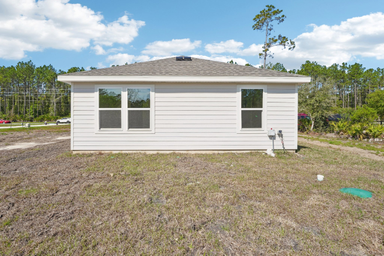 A house with a frisbee in the yard.