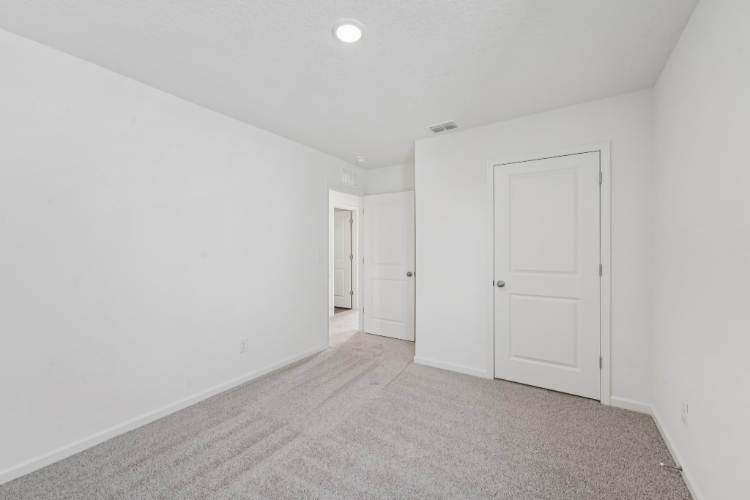 A hallway with white doors.