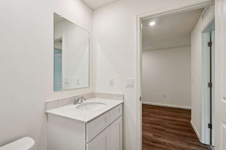 A bathroom with a sink and mirror.