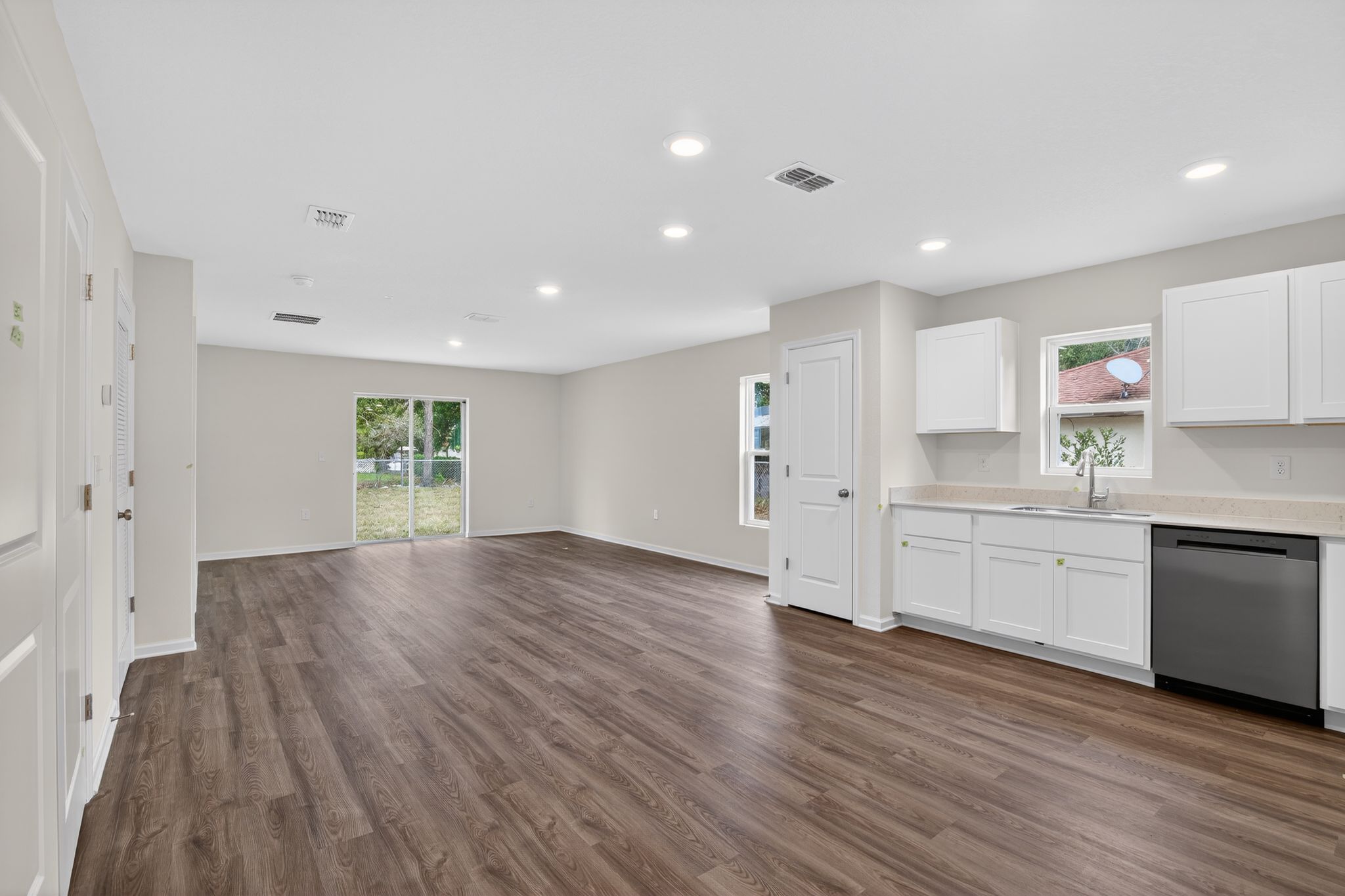 A large kitchen with white cabinets.
